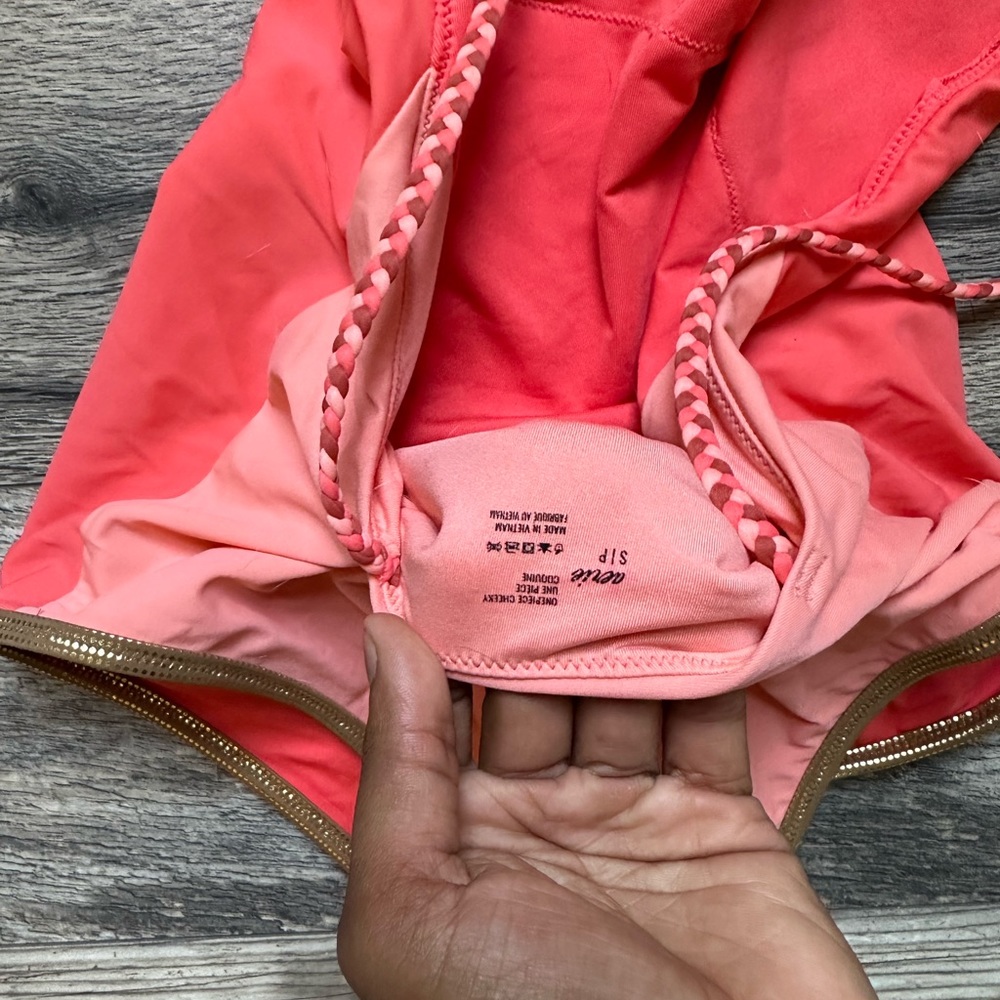 aerie, one piece , coral, gold and braided straps. good condition